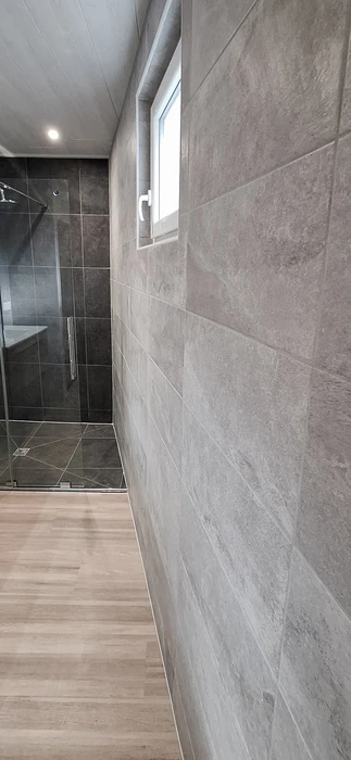 Couloir de salle de bains moderne avec sol en parquet stratifié imitation bois clair